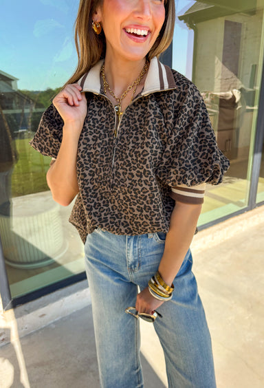 Give your everyday look a fierce twist with this leopard print puff sleeve top! The bold pattern is balanced by the multicolor band collar and half-zip front, making it the kind of piece you can throw on and still look completely put-together. It’s fun, a little wild, and ready for all your fall plans!