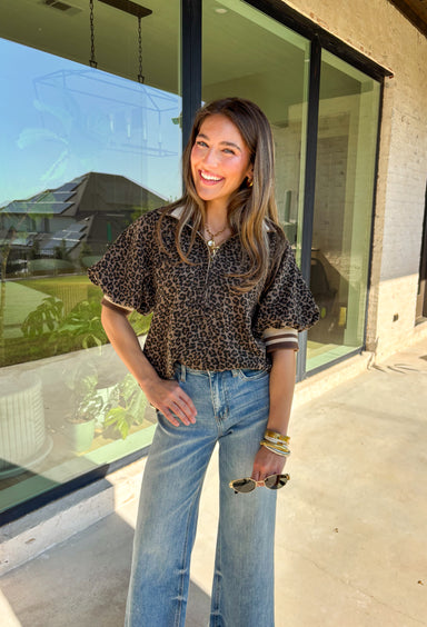 Give your everyday look a fierce twist with this leopard print puff sleeve top! The bold pattern is balanced by the multicolor band collar and half-zip front, making it the kind of piece you can throw on and still look completely put-together. It’s fun, a little wild, and ready for all your fall plans!
