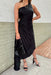 All Time Classic Dress, one shoulder pleated black dress with asymmetrical bottom and open circle on the right side of the dress 