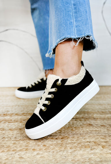 Endear Sneaker in Black, black sneaker with thick white sole, cream sherpa tongue and side hemming with cream laces