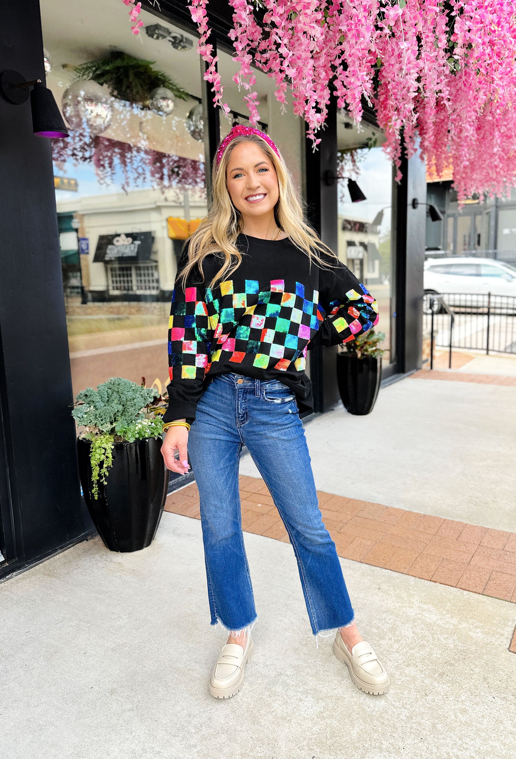 Checkmate Sequin Pullover, black crewneck with neon pink, blue, green, orange and yellow sequin checkered print across the chest and lower half of the sleeves g