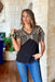 Easy To See Top, black short sleeve top with tan line embroidery on the upper part of the top 