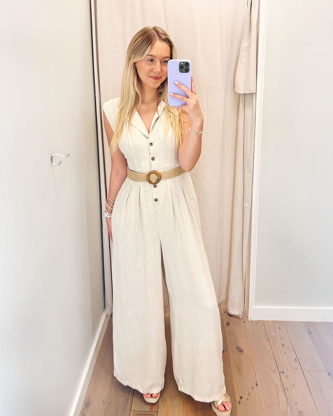 Where It Ends Linen Jumpsuit, Jumpsuit Featuring a neutral hue, wide leg, and button-up detail, this jumpsuit is elevated with a unique raffia and wooden belt detail