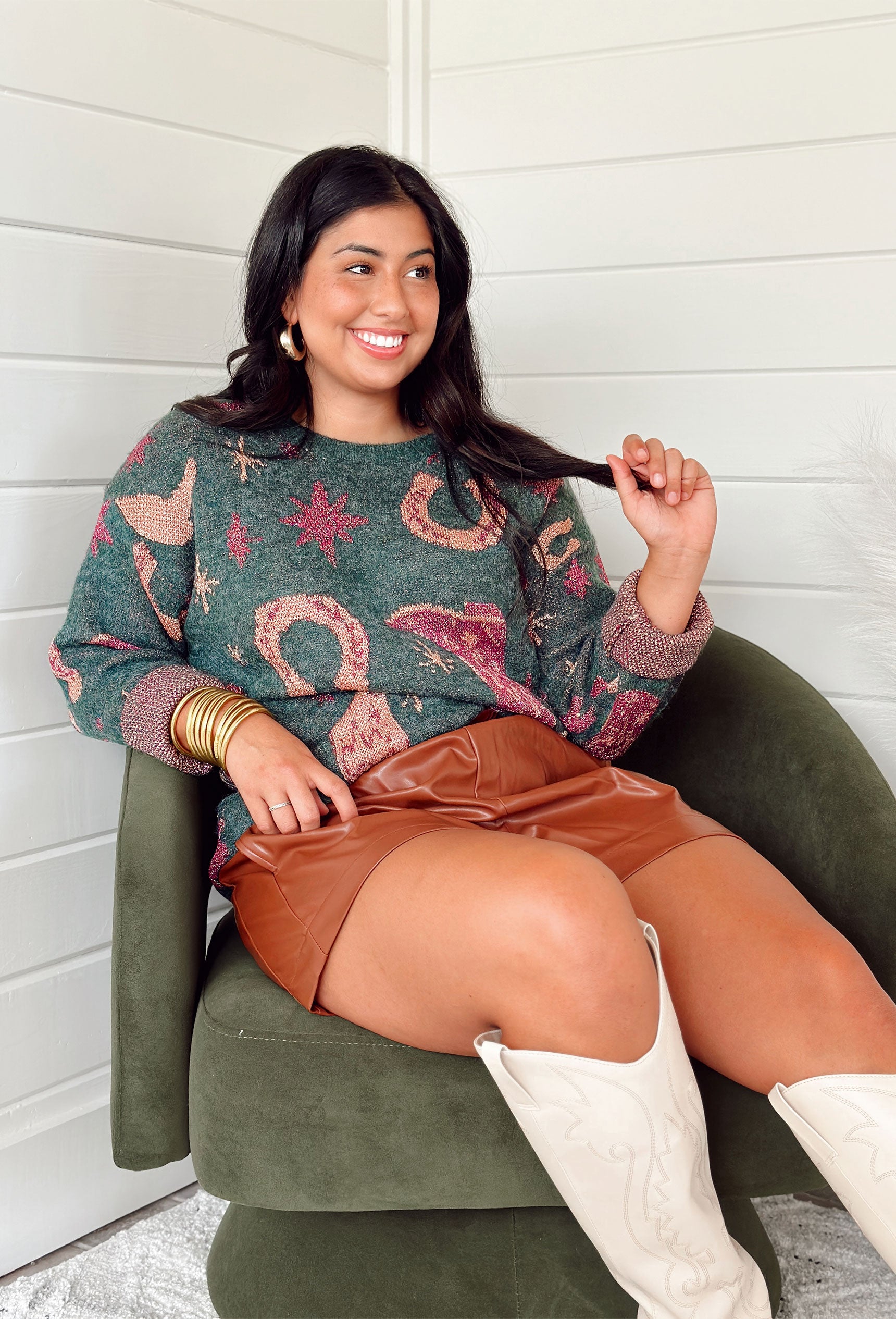Headed West Sweater, hunter green sweater with tinsel threading mixed in. tinsel threaded magenta stars, boots and horse shoes on the front and back of the sweater  