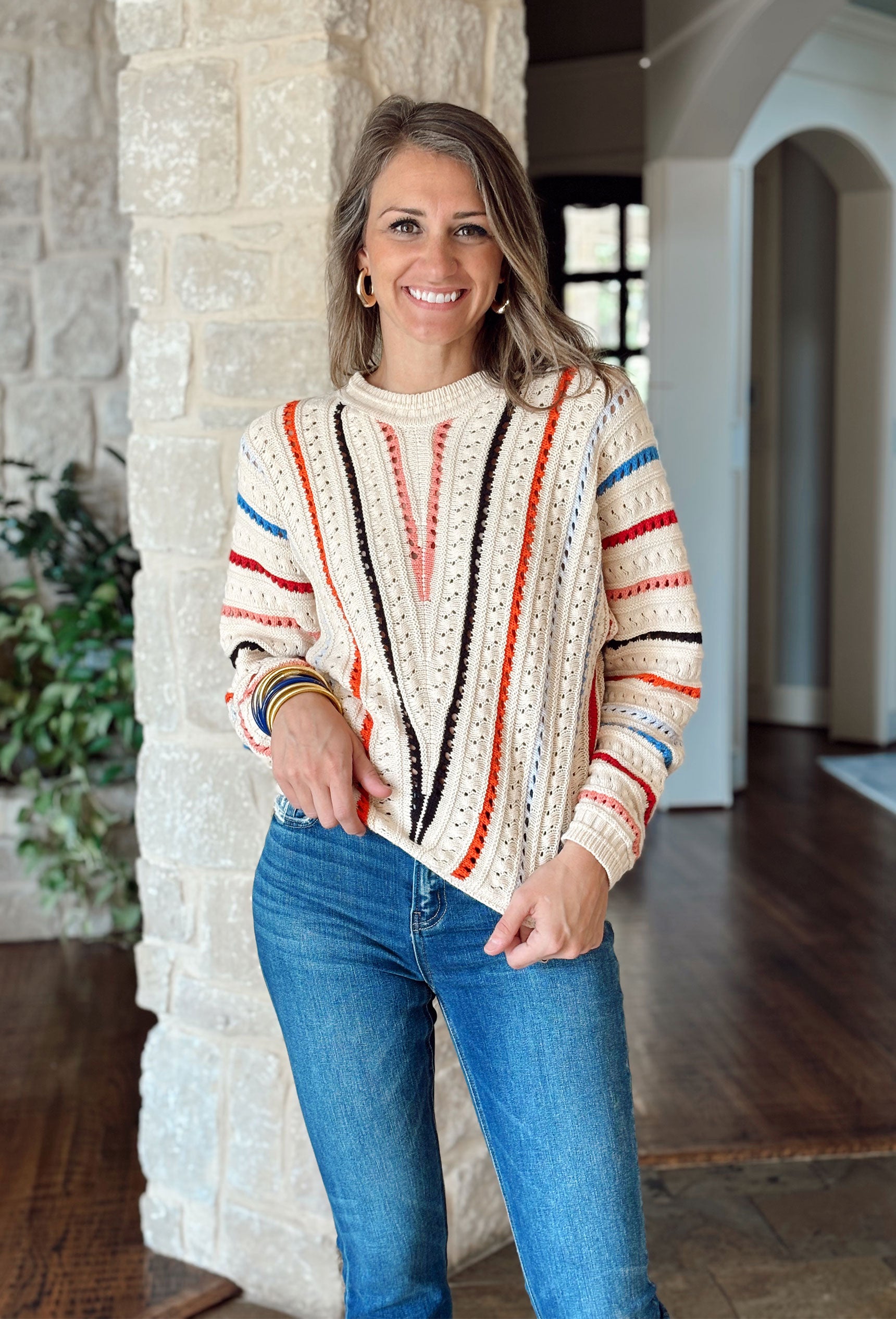 Just The Beginning Sweater, cream knit sweater with coral, black, red, orange, and blue vertical stripes