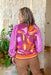 Lost In The Moment Sweater, fuchsia sweater  with orange, keylime, light pink and terracotta abstract floral designs on the chest. Sleeves are eyelet in fuchsia with keylime colored stripes down them 