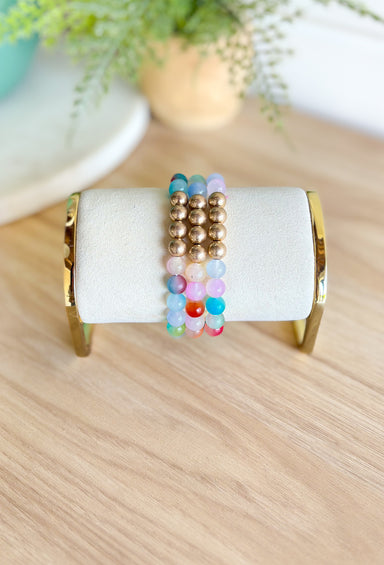 Much Happier Bracelet Set, stack of three multi color beaded bracelets with 4 gold beads in the center of each braclet