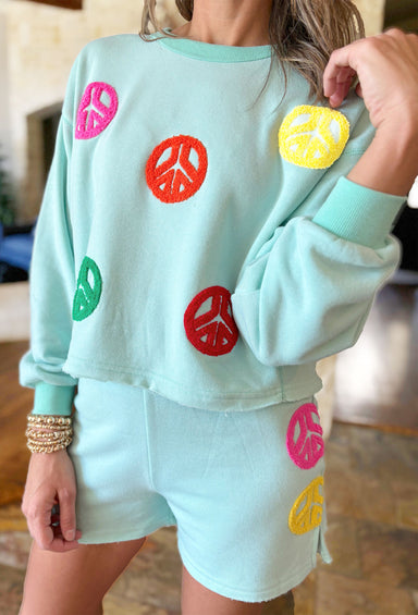 Peace & Love Lounge Set, teal sweatshirt and shorts with multi-colored peace signs 