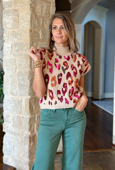 Running Wild Sweater, cream mock neck sweater vest with pink, maroon, orange, and army green leopard print