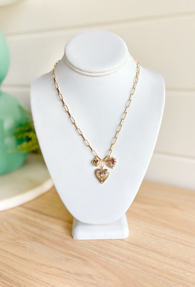 Your Heart And Soul Necklace, gold paper clip chain necklace with small solid gold puff heart, gold heart with rhinestones embedded and flat gold heart with line details surrounded in rhinestones