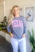 Charlie Southern Texas Pullover, grey pullover, light pink lettering with hot pink outlining saying "Texas" across the front 