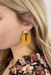 Clay U-Shape Drop Earrings, U-shape arches hang from a gold post, both with geometric detail