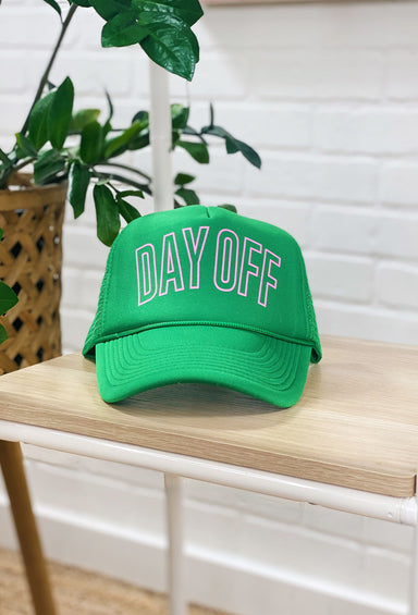 Day Off Trucker Hat in Green, green trucker hat with green mesh in the back, adjustable, "day off" written in pink block letters on the front