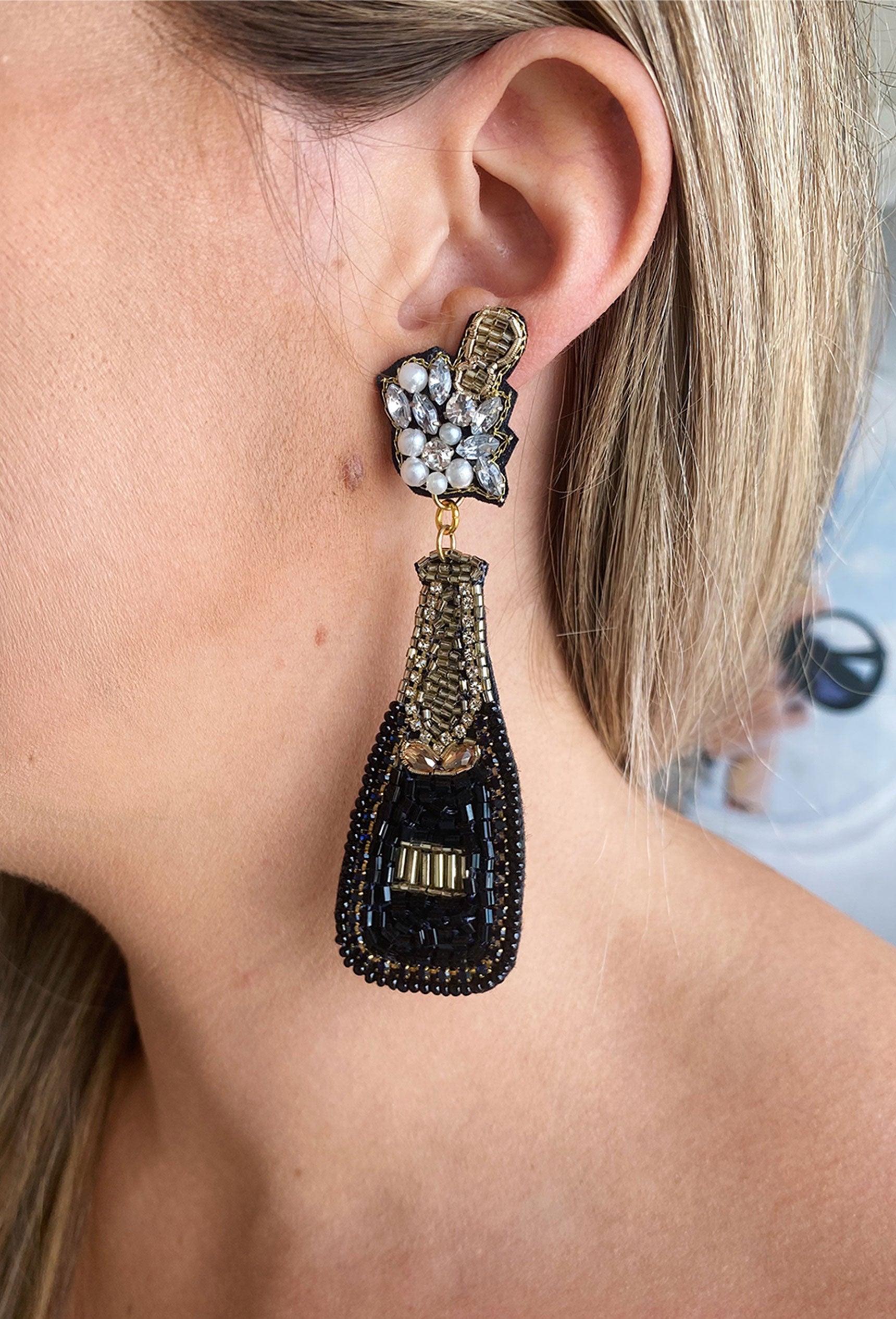 Endless Nights Bottle Beaded Earrings, black and gold beads in the shape of a champagne bottle, cork popping off, post backing
