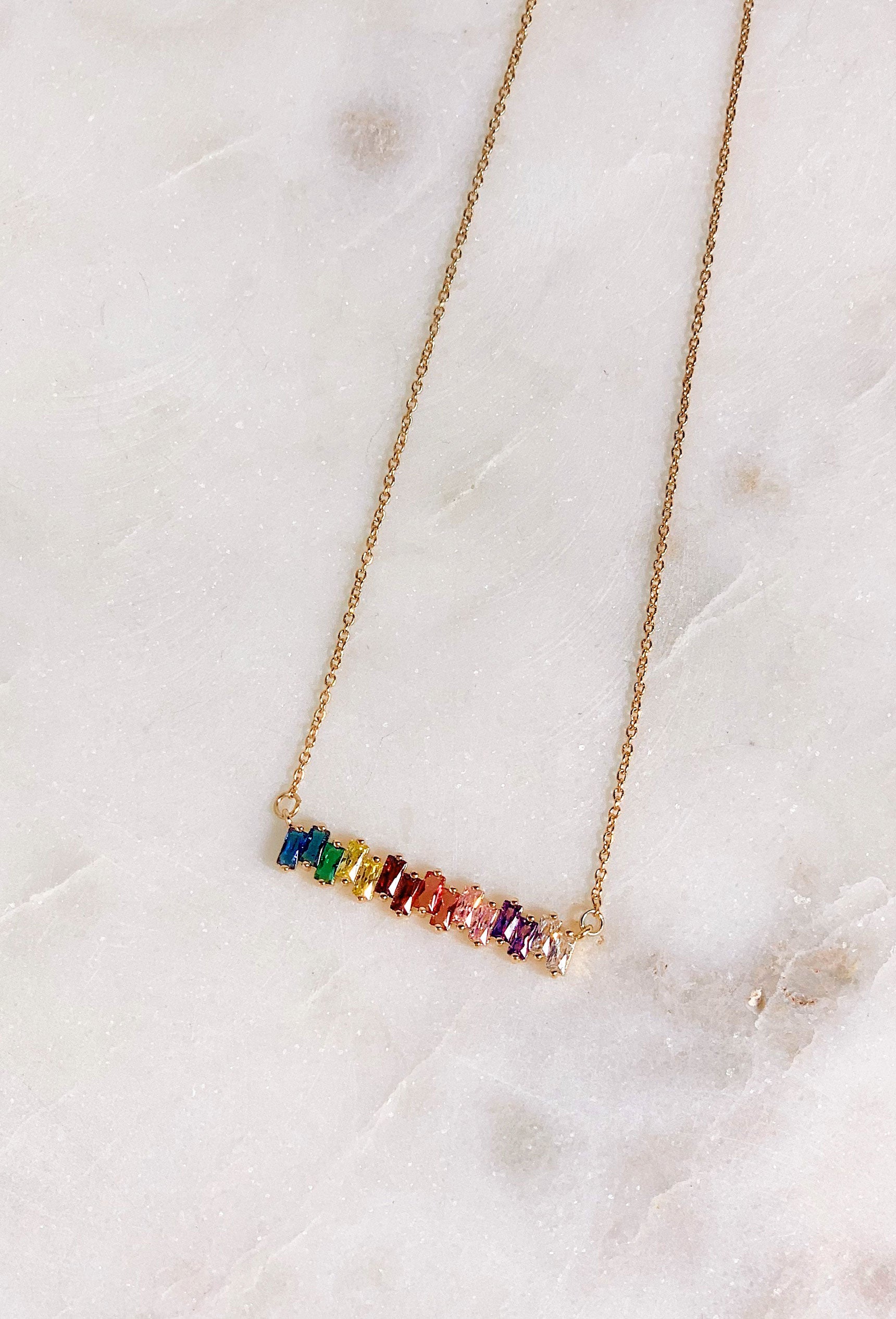 Hazel Rainbow Crystal Bar Necklace, 15 colored rainbow stones alined in a bar necklace on gold chain 