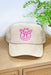Hey Cowboy Trucker Hat, light tan hat with pink embroidered smiley face wearing a cowboy hat