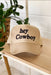 Hey Cowboy Trucker Hat, tan trucker hat with mesh back, adjustable strap, and "hey cowboy" embroidered on the front