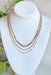 It Girl Layered Necklace in Blue, variety of different gold chains, one chain with shades of blue beads