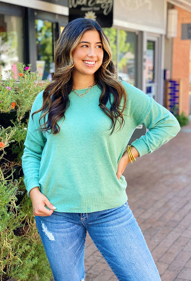 Lilly Sweater by Dreamers in Heathered Aloe Vera, green sweater, ribbed cuffs, open neckline that can be worn off the shoulder