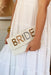 Metallic Bride Beaded Handbag, white beaded bag with "BRIDE" beaded in metallic colors across the top flap. removable crossbody chain