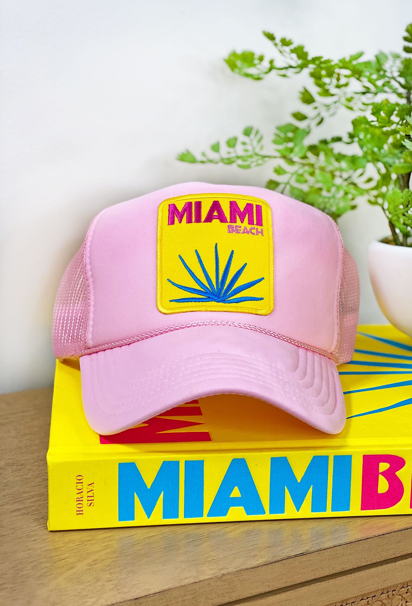 Miami Beach Trucker Hat, light pink trucker hat with yellow Miami Beach patch on the front