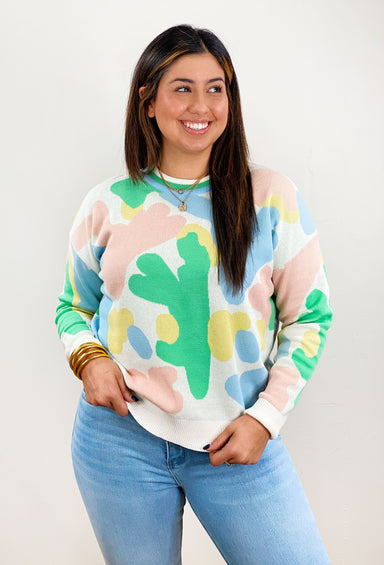New York Nights Sweater, white sweater with yellow, pink and green abstract design, striped neckline