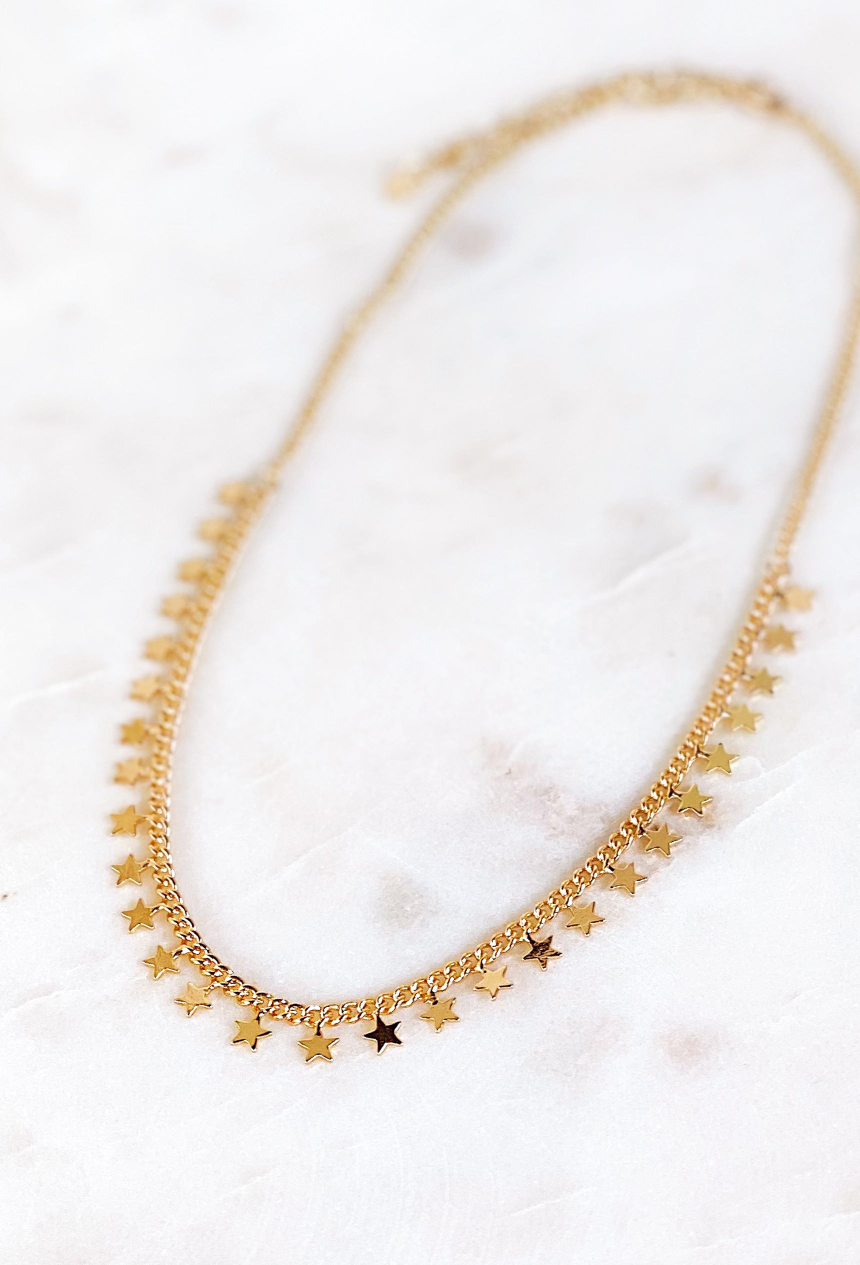 Stars Have Aligned Gold Necklace, gold chain necklace with stars lines up on the bottom half 