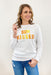 Sun Kissed Pullover, white pullover with "sun kissed" patches in different shades of yellow and orange across the chest