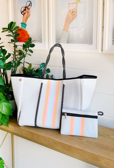 The Jeanne Neoprene Tote, soft antelope print tote with cream and white detailing , cobalt blue neoprene tote with green and white stripe detailing , white neoprene tote bag with pastel stripes down the front and pastel tie dye lining 