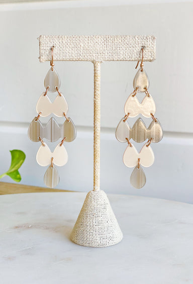 Tell Me Everything Drop Earrings In Neutral. diamond shaped drop earring, teardrop shaped resin pieces attached to form a diamond shape 