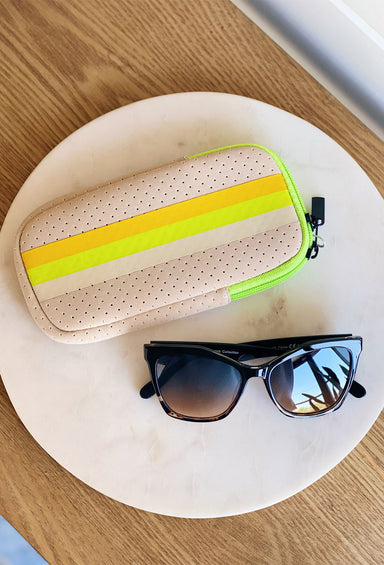 The Eve Neoprene sunglass case, creme colored bag, yellow and green stripes down middle, double zipper closure