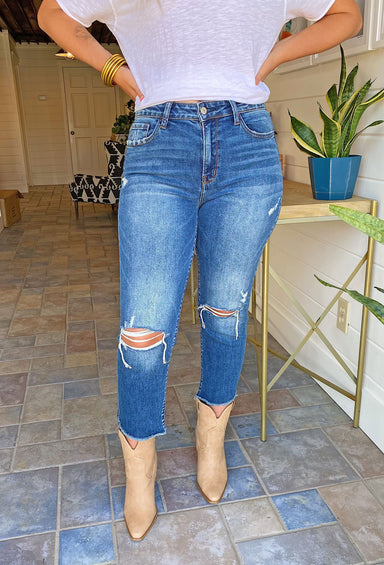 Victoria High-Rise Stretch Straight Jeans, navy blue denim, distressing at the knees, cropped at the bottom 