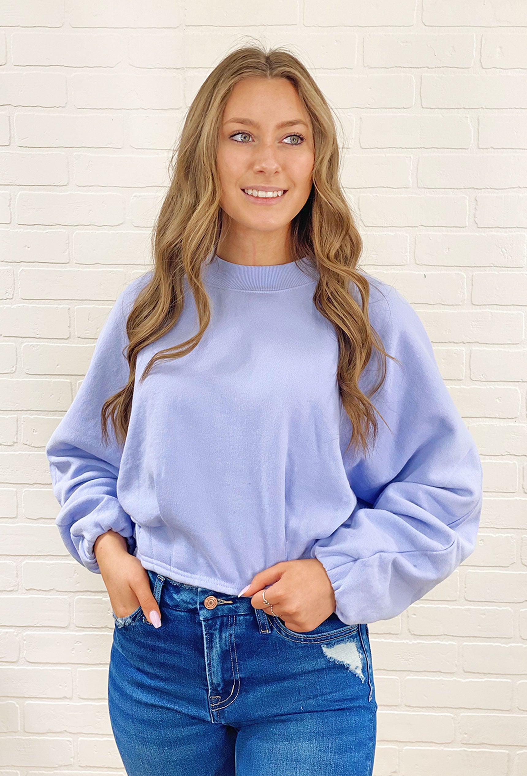 Z SUPPLY Mariana Pleated Sweatshirt, lavender colored top with pleated detail at the bottom